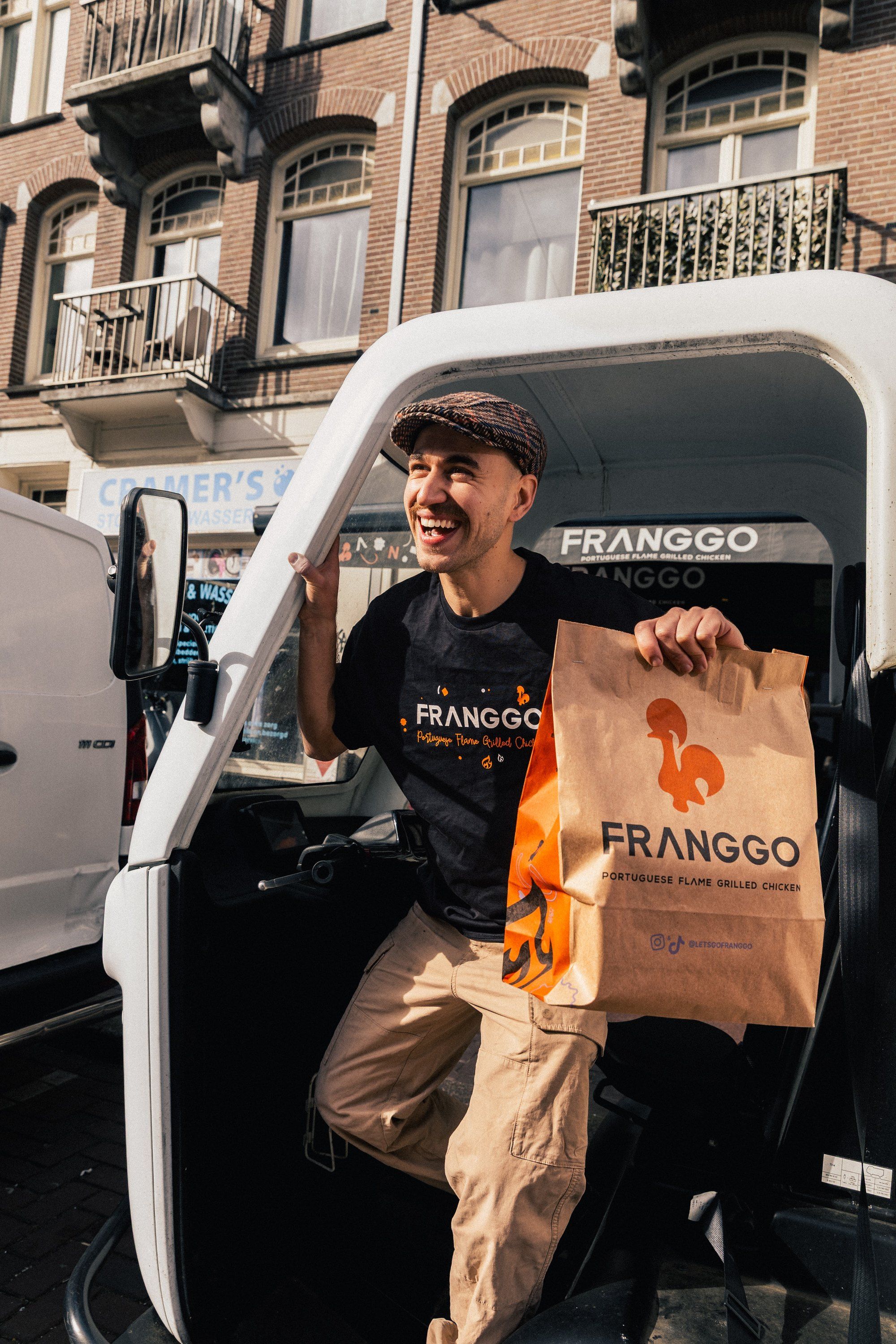 Max in the Franggo delivery van with a Franggo bag